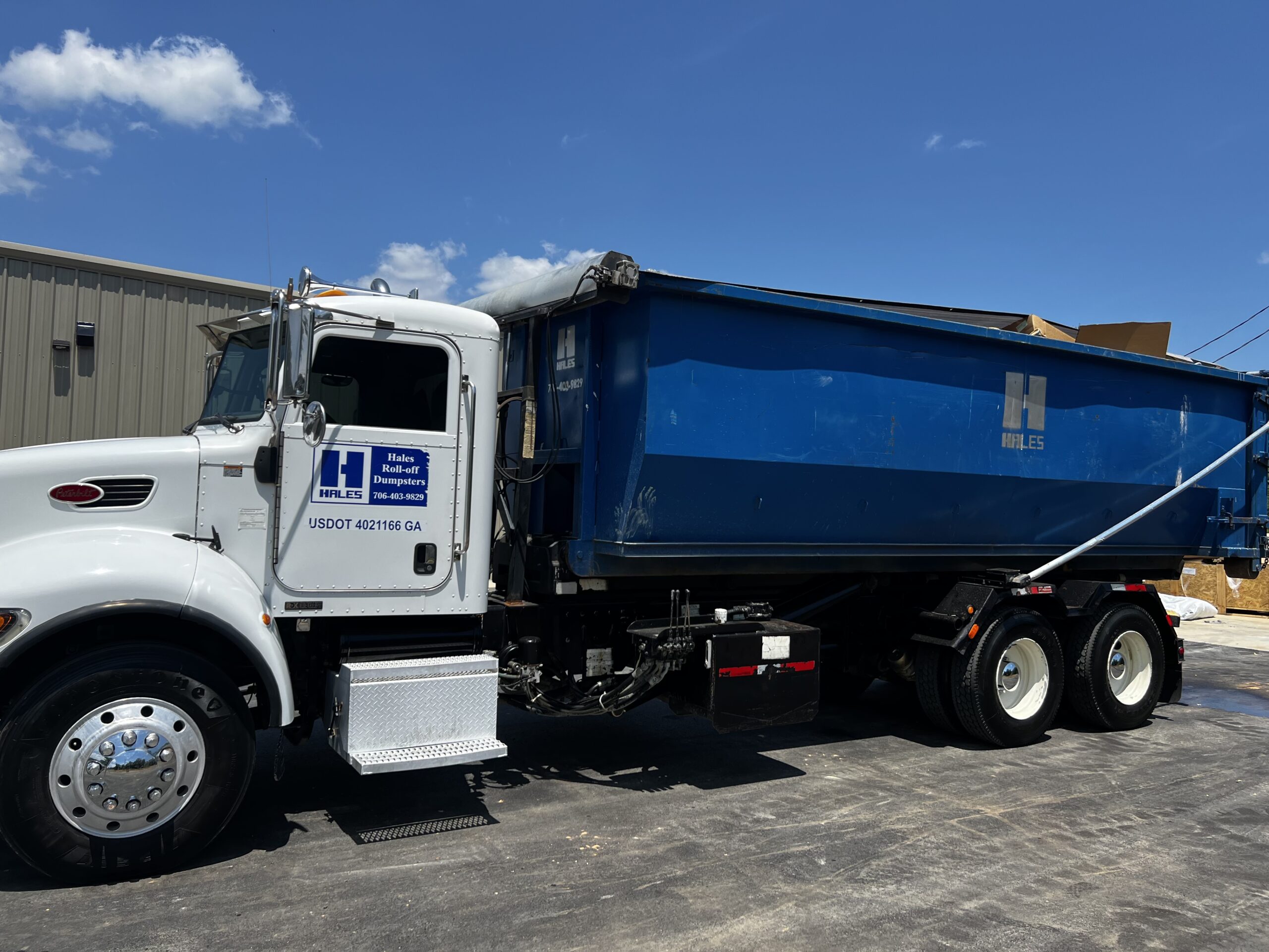 Large blue roll-off dumpster available for residential and commercial dumpster rentals in Northwest Georgia.