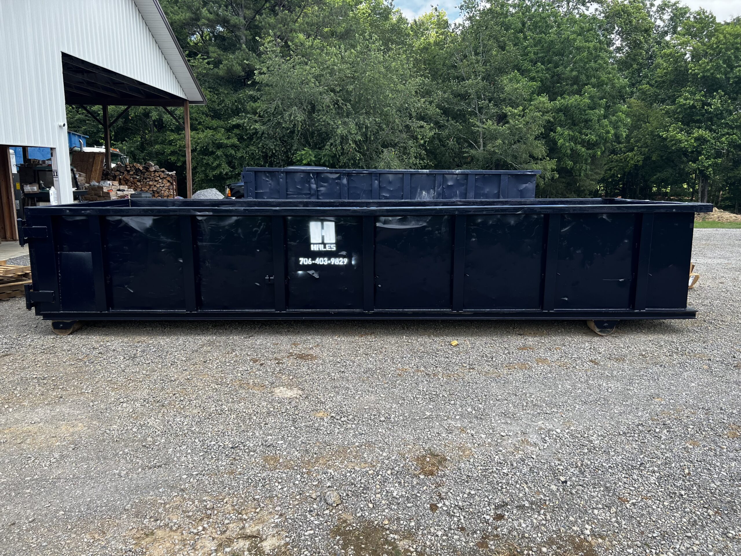 Large roll-off dumpster placed for cleanup at a residential property. 